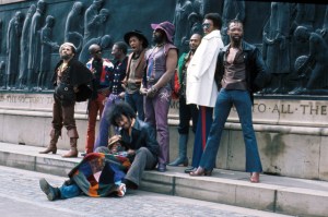 LIVERPOOL, ENGLAND - MAY 1971:  (L-R) Fuzzy Haskins, Tawl Ross, Bernie Worrell, Tiki Fulwood, Grady Thomas, George Clinton, Ray Davis, Calvin Simon and seated Eddie Hazel and Billy "Bass" Nelson of the funk band Parliament-Funkadelic pose for a portrait in May 1971 in Liverpool, England. (Photo by Michael Ochs Archives/Getty Images)